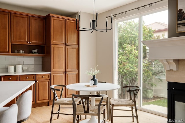8122 E 6th Pl, Denver, CO 80230 - dining space with a chandelier and light wood-style floors