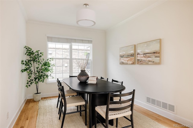 8122 E 6th Pl, Denver, CO 80230 - dining area featuring crown molding, light wood-type flooring, and baseboards
