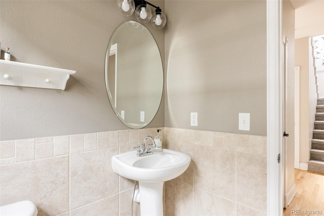 8122 E 6th Pl, Denver, CO 80230 - bathroom with tile walls, toilet, and a wainscoted wall