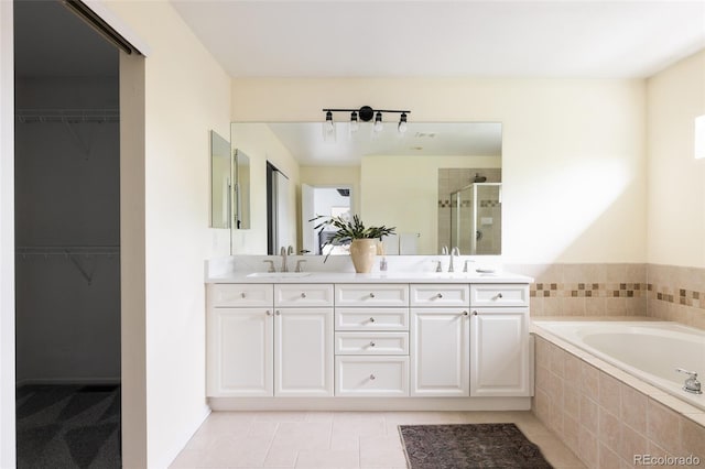 8122 E 6th Pl, Denver, CO 80230 - bathroom with a stall shower, double vanity, a garden tub, and a spacious closet