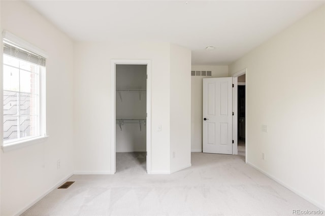 8122 E 6th Pl, Denver, CO 80230 - unfurnished bedroom featuring light carpet, a spacious closet, and baseboards