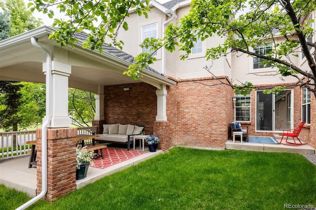 8122 E 6th Pl, Denver, CO 80230 - rear view of property with a patio, outdoor lounge area, brick siding, and a yard