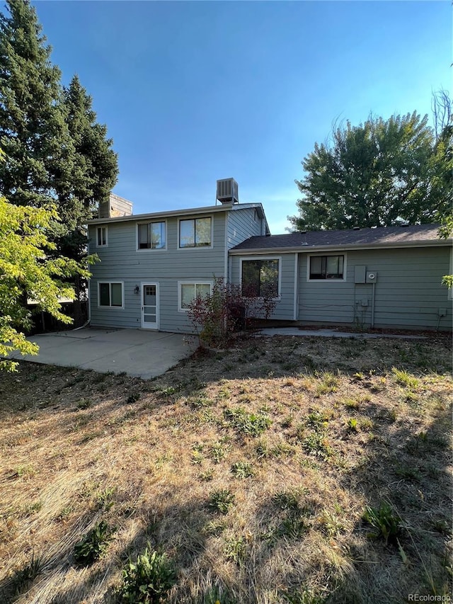 back of property with a patio and central AC