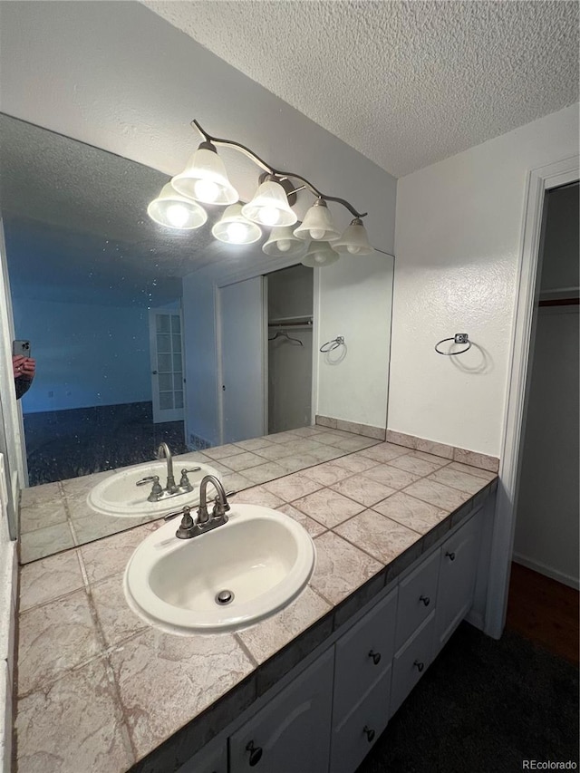 bathroom featuring vanity and a textured ceiling