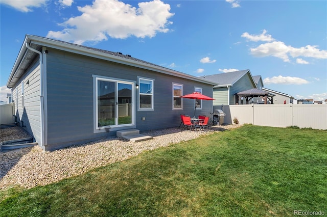 rear view of house with a yard