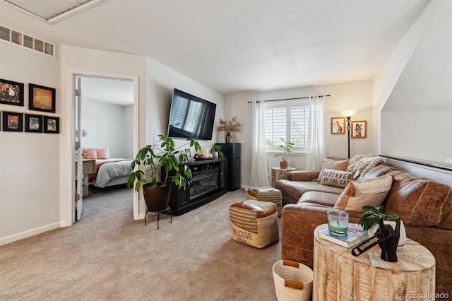 carpeted living room featuring a textured ceiling