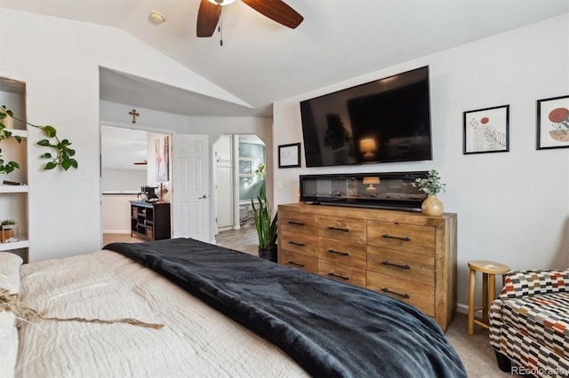 bedroom with light colored carpet, ceiling fan, and vaulted ceiling