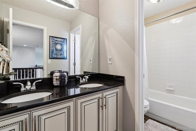 full bathroom with vanity, toilet, and tiled shower / bath combo