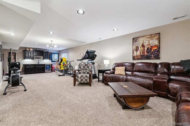 carpeted living room with bar area and wine cooler