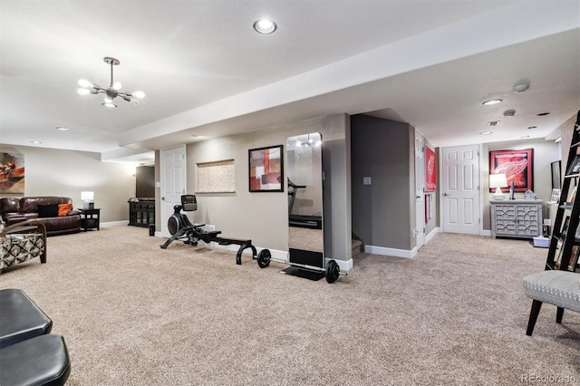 workout area featuring a chandelier and carpet