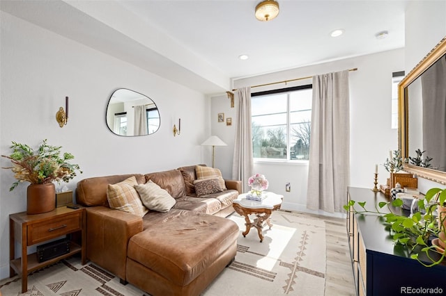 living area with recessed lighting and light wood-style flooring