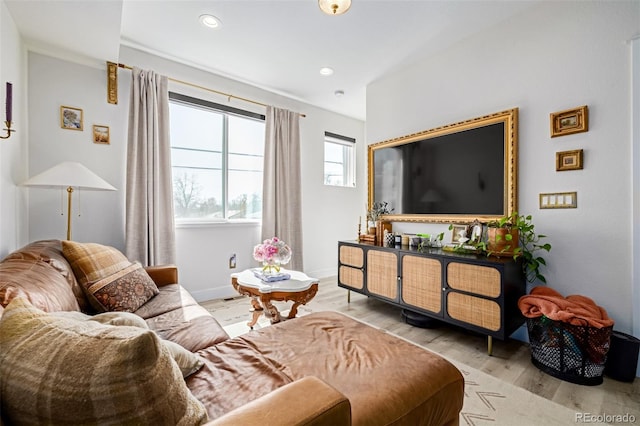 living room featuring recessed lighting, wood finished floors, and baseboards