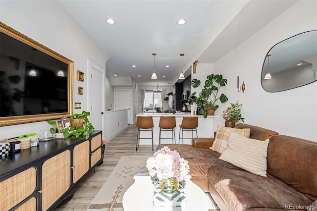 living area featuring recessed lighting and light wood-style floors