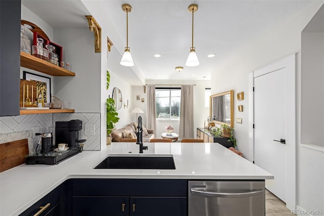 kitchen featuring a sink, backsplash, open shelves, a peninsula, and stainless steel dishwasher