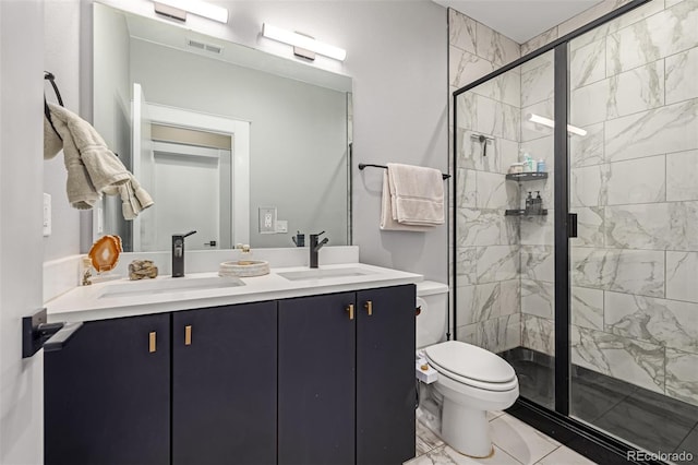 bathroom featuring a shower stall, double vanity, marble finish floor, and a sink