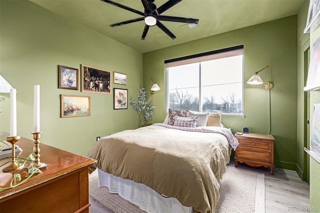 bedroom with light wood finished floors and a ceiling fan