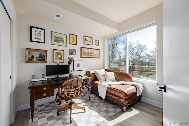 home office with visible vents, baseboards, and light wood-style floors