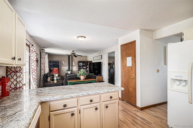 34181 Columbine Trl, Elizabeth, CO 80107 - kitchen featuring white fridge with ice dispenser, a peninsula, light wood-style flooring, a textured ceiling, and ceiling fan