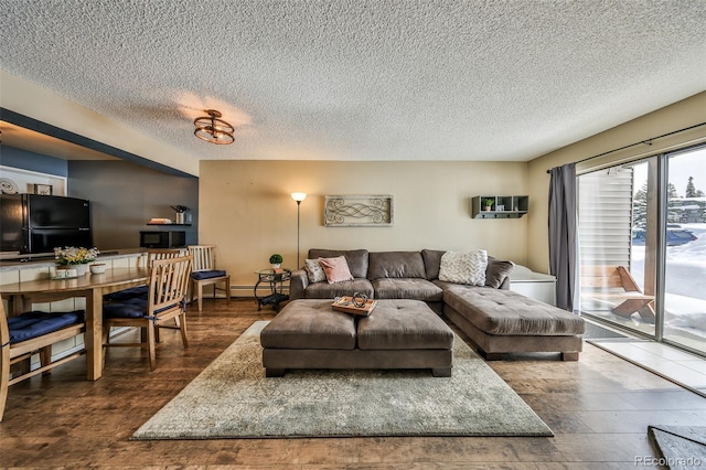 living room featuring a textured ceiling, wood finished floors, and a baseboard radiator