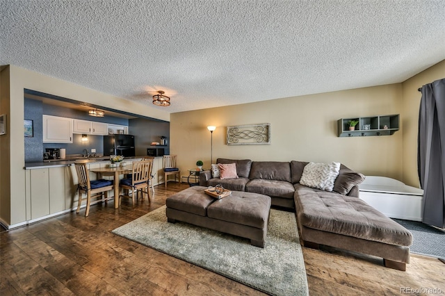 living room featuring a textured ceiling and wood finished floors