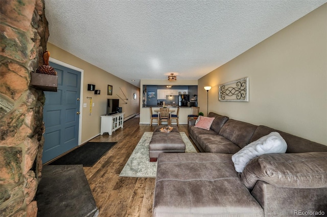 living room with dark wood-style floors and a textured ceiling