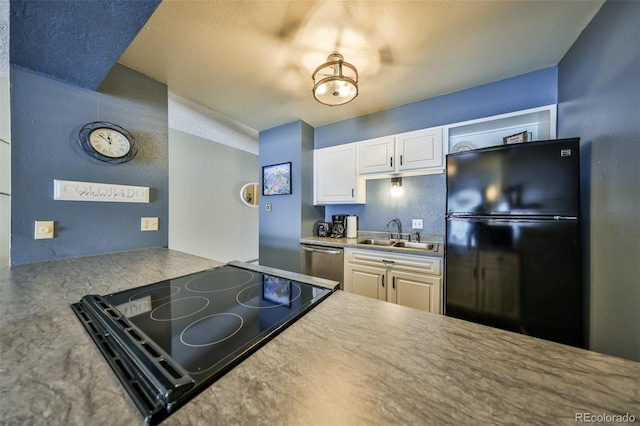 kitchen featuring white cabinetry, black appliances, light countertops, and a sink