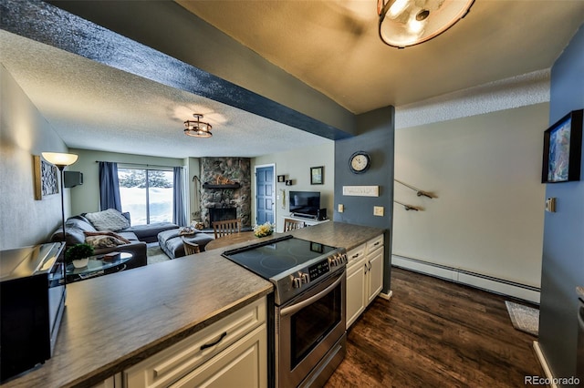 kitchen with baseboard heating, stainless steel electric range, a textured ceiling, and open floor plan