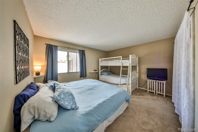 carpeted bedroom with a textured ceiling and baseboards