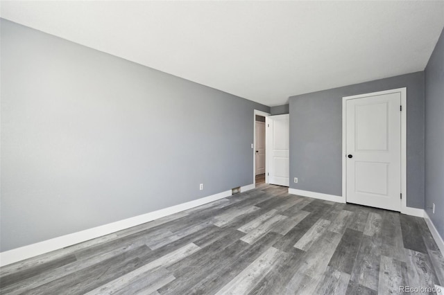 unfurnished bedroom featuring dark hardwood / wood-style floors