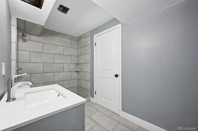 bathroom with tile patterned floors and vanity