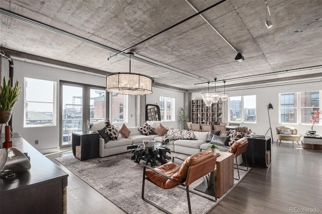 1735 19th St Unit 6D, Denver, CO 80202 - living area with healthy amount of natural light, a chandelier, and wood finished floors
