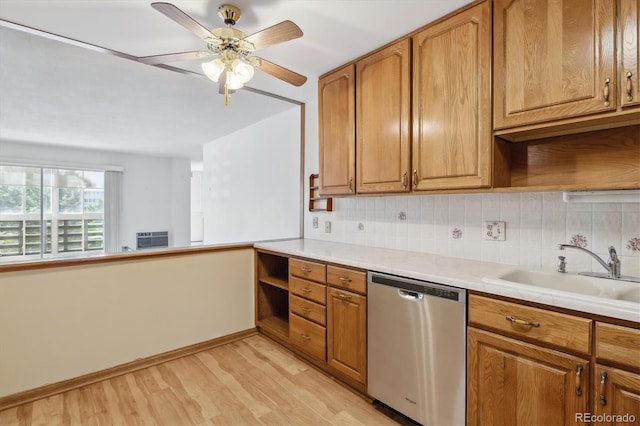 kitchen featuring dishwasher, backsplash, sink, ceiling fan, and light wood-type flooring