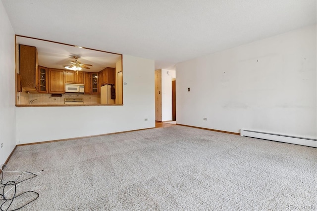 unfurnished living room featuring baseboard heating, light colored carpet, and ceiling fan