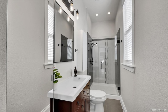 bathroom with plenty of natural light, a stall shower, and vanity