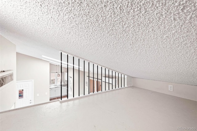 unfurnished room with a textured ceiling