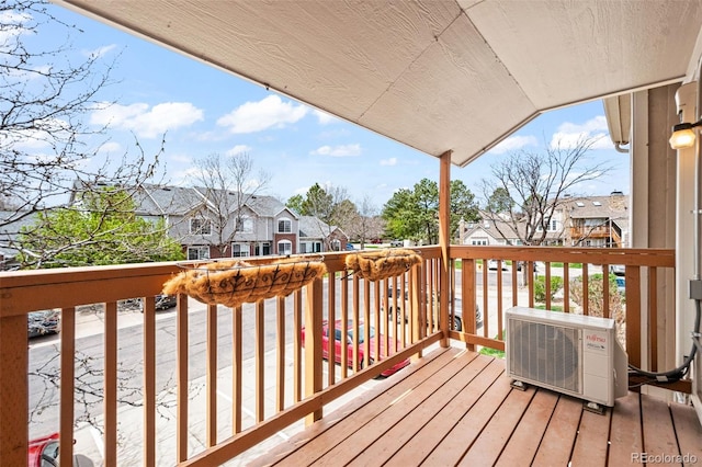 deck featuring a residential view and ac unit