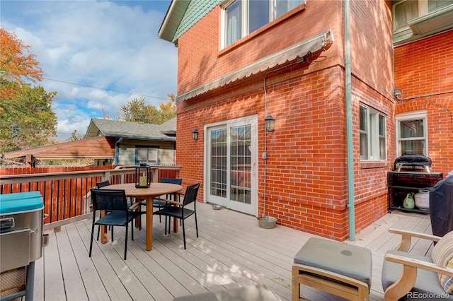 wooden deck featuring outdoor dining area