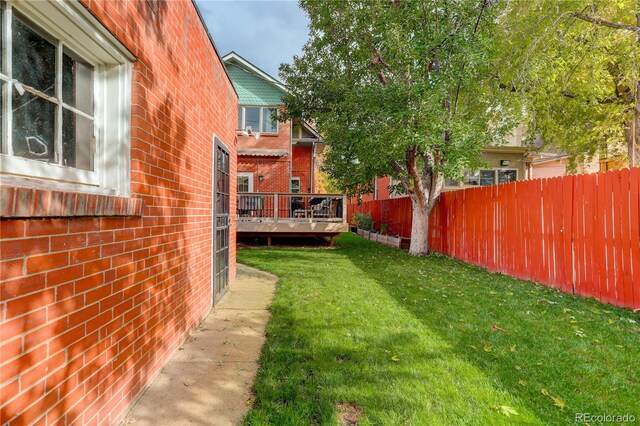 view of yard with a deck and fence