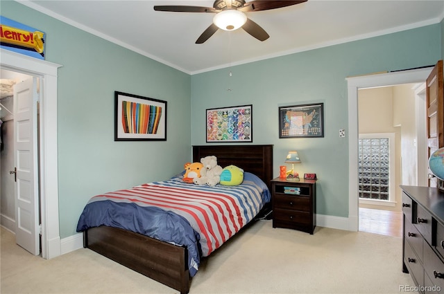 bedroom with a ceiling fan, light colored carpet, crown molding, and baseboards