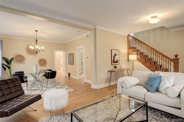 living room with light wood-style floors, baseboards, stairs, and ornamental molding