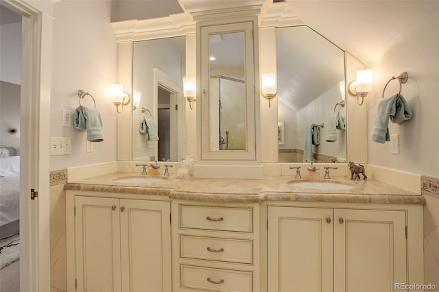 ensuite bathroom with double vanity, a sink, and ensuite bathroom