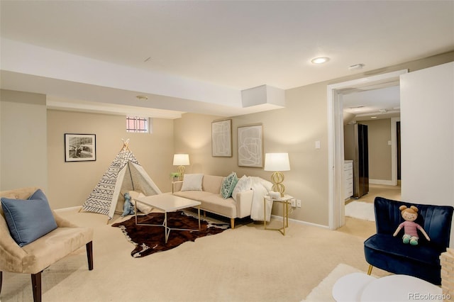 carpeted living area featuring baseboards and recessed lighting