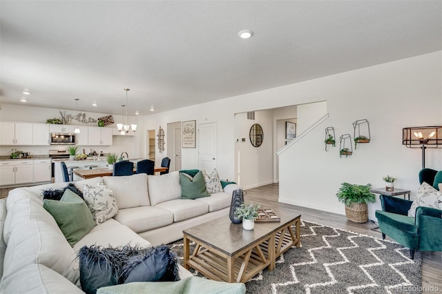 living room featuring hardwood / wood-style flooring and a notable chandelier