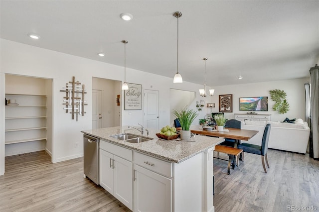 kitchen with dishwasher, white cabinets, light hardwood / wood-style flooring, and sink