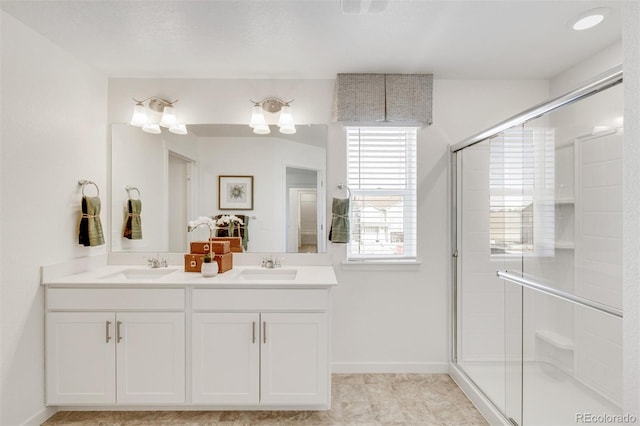 bathroom featuring tile patterned floors, a shower with door, and vanity