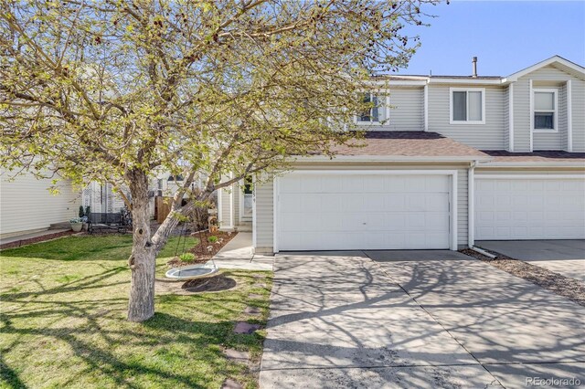 multi unit property featuring a garage, roof with shingles, a front lawn, and concrete driveway