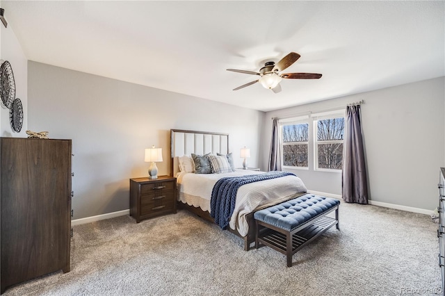 bedroom with light colored carpet, ceiling fan, and baseboards