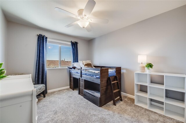 carpeted bedroom with baseboards and ceiling fan