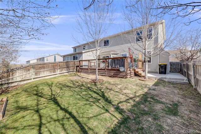 back of house with a lawn, a patio, a fenced backyard, and a deck