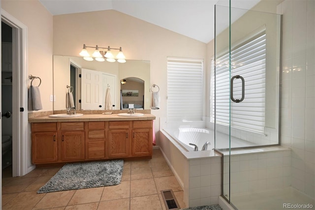 1386 Avgare Way, Erie, CO 80516 - bathroom featuring lofted ceiling, a garden tub, double vanity, a stall shower, and tile patterned floors